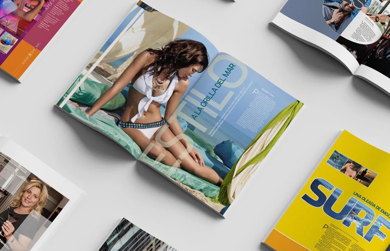 A scatter of open Club magazine spreads and covers on a light surface