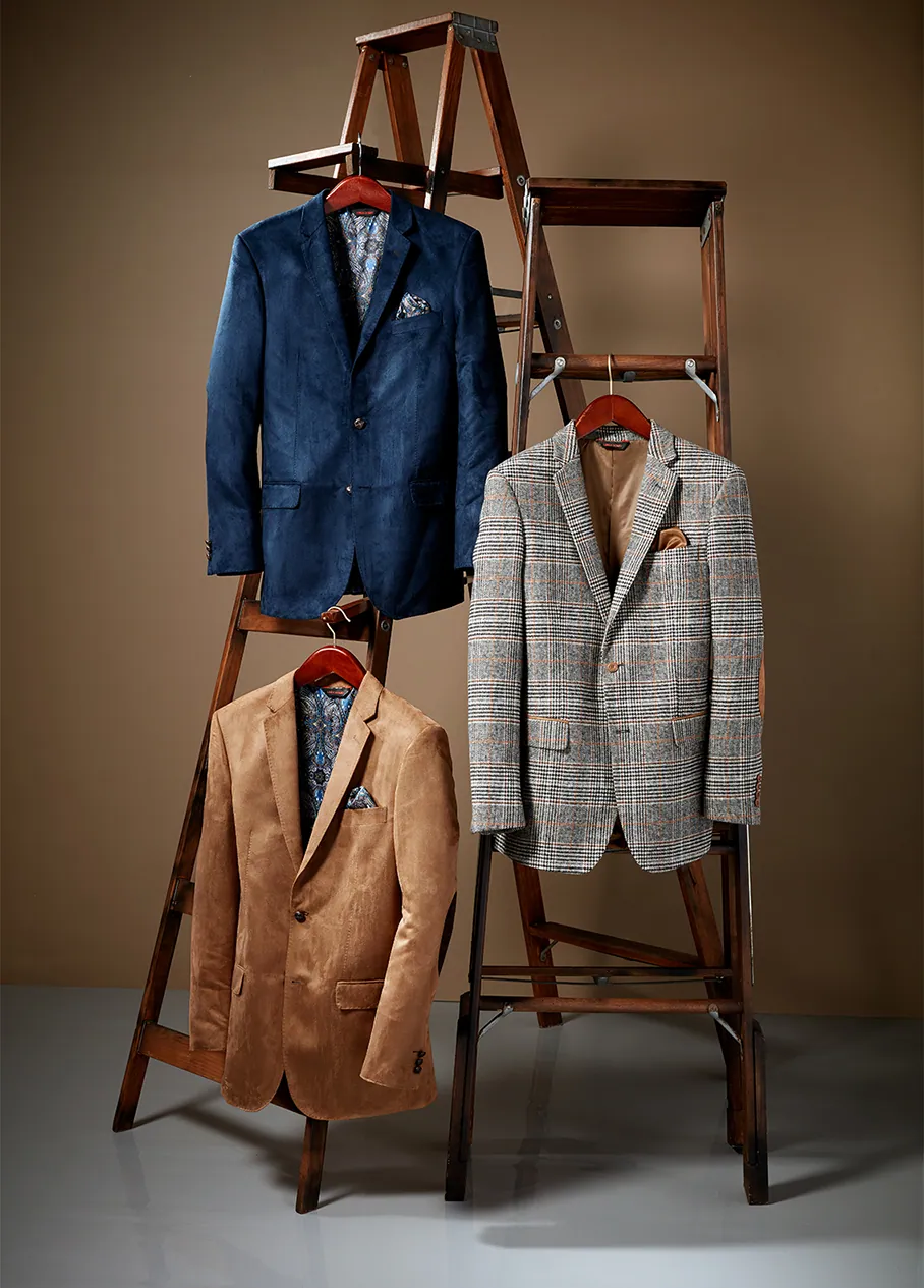Still life of men’s jackets hung on a wooden ladder