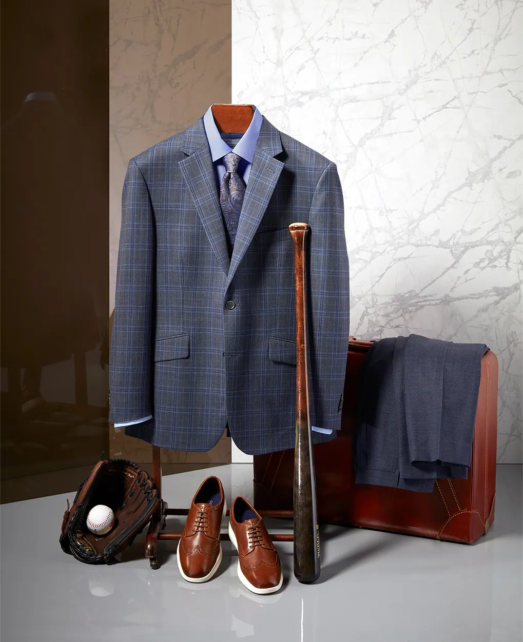 Still life of a navy suit with shoes and accessories